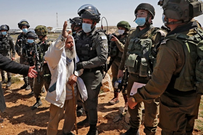 Palestinian man confronting Israeli army