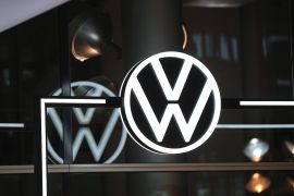 A Volkswagen AG (VW) logo sits on display as a VW ID.3 electric automobile, the first of around 22 million vehicles to be produced and delivered worldwide by 2028, is handed over to a customer
