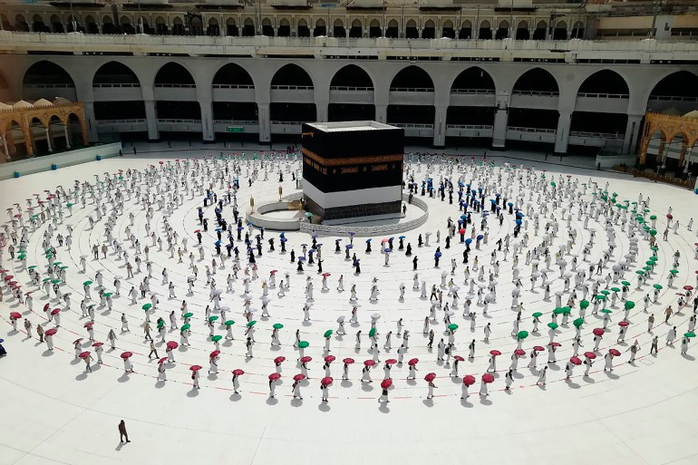Hundreds of Muslim pilgrims circumambulate the Kaaba, the cubic building at the Grand Mosque, as they keep social distance to protect themselves from the coronavirus [File: AP]