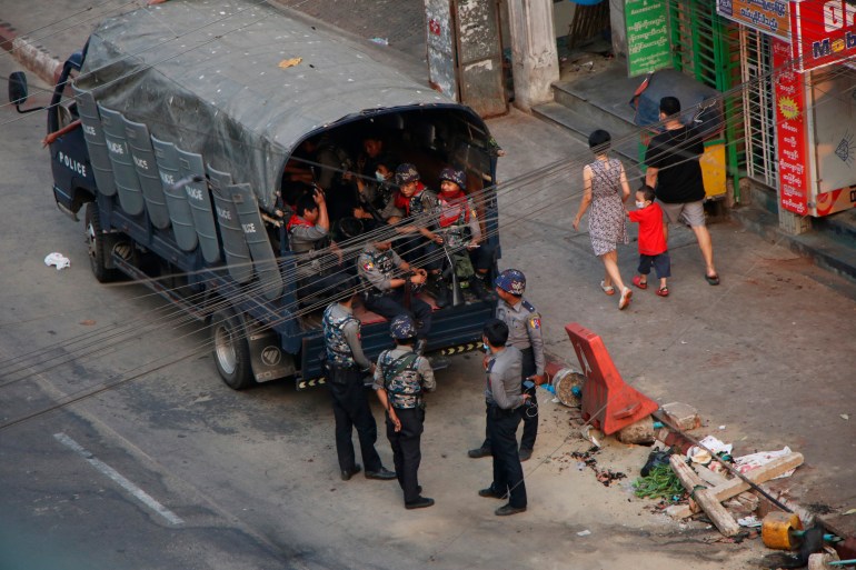 Myanamr security forces in the back of a truck