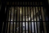 A guard stands behind bars at the Adjustment Center during a media tour of California&#39;s Death Row at San Quentin State Prison in San Quentin, California December 29, 2015. America&#39;s most populous state, which has not carried out an execution in a decade, begins 2016 at a pivotal juncture, as legal developments hasten the march toward resuming executions, while opponents seek to end the death penalty at the ballot box. To match Feature CALIFORNIA-DEATH-PENALTY/ Picture taken December 29, 2015. REUTERS/Stephen Lam