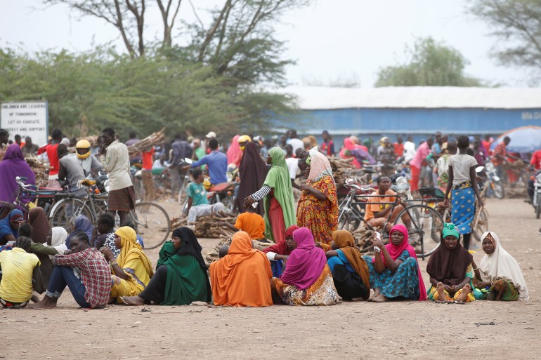 Women wait in line to receive aid at the Kakuma refugee camp in northern Kenya, March 6, 2018.