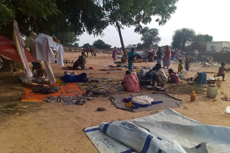 residents displaced from a surge of violent attacks squat on blankets and in hastily made tents in the village of Masteri in west Darfur, Sudan.