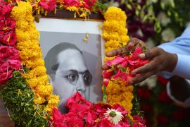 People offer floral tributes to a portrait of Bhimrao Ambedkar on his birth anniversary in Hyderabad, India on April 14, 2021 [AP/Mahesh Kumar A]