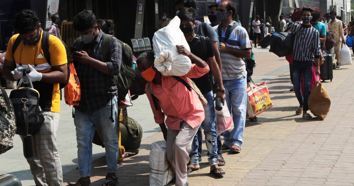 India: migrant workers leave cities as COVID measures bite