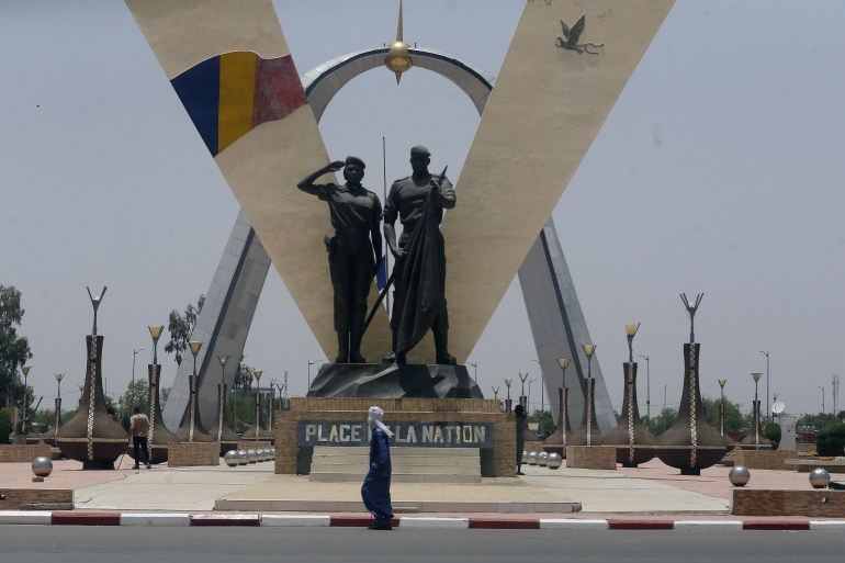 A man walks past "Place de Le Nation" (Monument of independence) park in N'Djamena, Chad, Monday, April 26, 2021. Chad's military transitional government said Sunday it will not negotiate with the rebels blamed for killing the country's president of three decades, raising the specter that the armed fighters might press ahead with their threats to attack the capital.