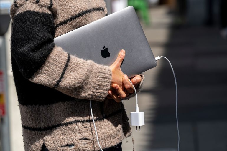 The world’s largest technology company has mostly thrived during the pandemic as a wave of people working from home fired up demand for tech products like laptops [File: David Paul Morris/Bloomberg]