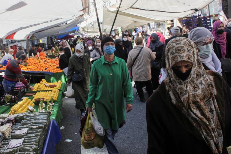 People wearing protective face masks shop at a fresh market, amid the coronavirus disease (COVID-19) pandemic, in Istanbul, Turkey