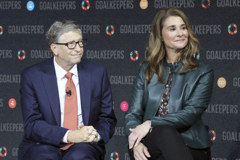 Bill and Melinda Gates look to the audience at a conference