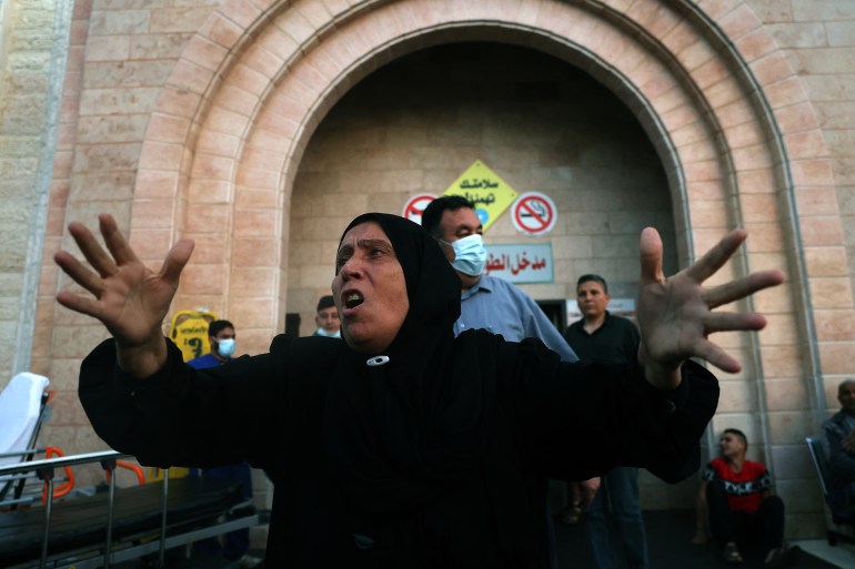 A Palestinian woman reacts outside a hospital in the northern Gaza Strip [Mohamed Abed/AFP]