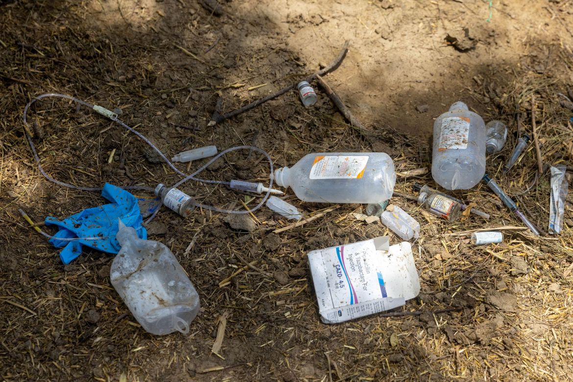 Infusion bags and other medication that were used to treat villagers with breathing difficulties are seen at the makeshift open-air clinic. [Danish Siddiqui/Reuters]