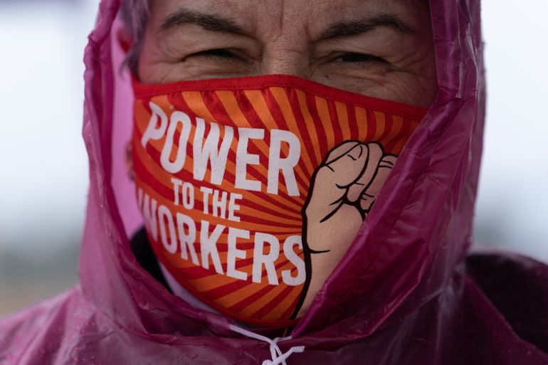 A demonstrator wears a protective mask that reads "Power To The Workers" during a Retail, Wholesale and Department Store Union (RWDSU) held protest outside the Amazon.com Inc. BHM1 Fulfillment Center in Bessemer, Alabama, U.S.