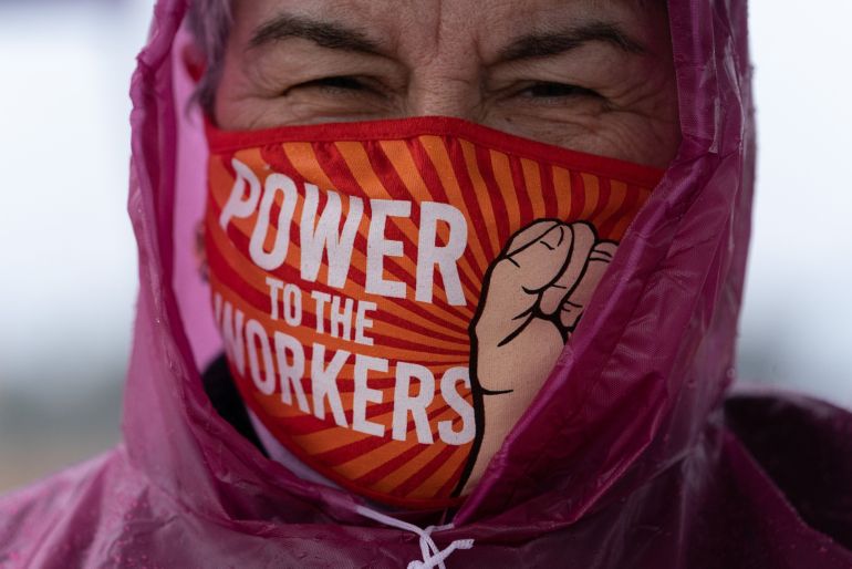 A demonstrator wears a protective mask that reads "Power To The Workers" during a Retail, Wholesale and Department Store Union held protest outside the Amazon Center in Bessemer, Alabama in the US.