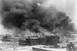 In this 1921 image provided by the Library of Congress, smoke billows over Tulsa, Okla. For decades, when it was discussed at all, the killing of hundreds of people in a prosperous black business district in 1921 was referred to as the Tulsa race riot. Under new standards developed by teachers for approaching the topic, students are encouraged to consider the differences between labeling it a “massacre” instead of a “riot,” as it is still commemorated in state laws. (Alvin C. Krupnick Co./Library of Congress via AP)