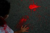 A person places a handprint with red paint on a pavement during a protest in Sao Paulo, Brazil against police violence two days after a police operation in Rio de Janeiro’s Jacarezinho favela resulted in the death of 28 people. Sao Paulo, Brazil, May 8, 2021 [Amanda Perobelli/Reuters]
