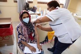 A healthcare worker receives a dose of the Johnson &amp; Johnson vaccine against the COVID-19 coronavirus at the Klerksdorp Hospital, South Africa