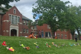 Flowers and tributes are laid out in front of Kamloops Indian Residential School