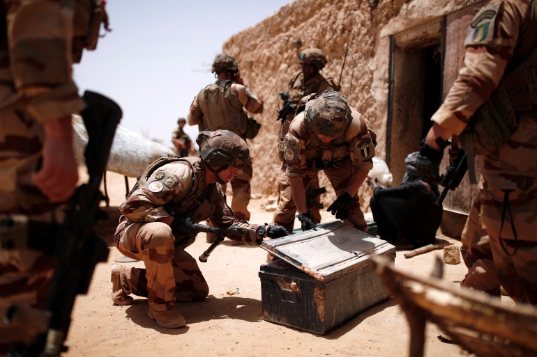 French soldiers of the 2nd Foreign Engineer Regiment search a metal case during an area control operation in the Gourma region during Operation Barkhane in Ndaki, Mali