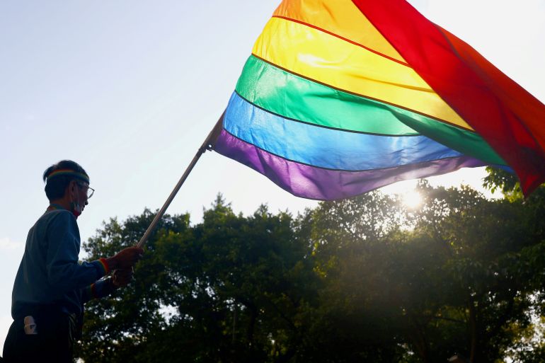 A gay pride flag waves during a protest