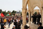 Israeli forces face Palestinian protesters at the compound that houses Al-Aqsa Mosque on May 21, 2021 [Reuters/Ammar Awad]