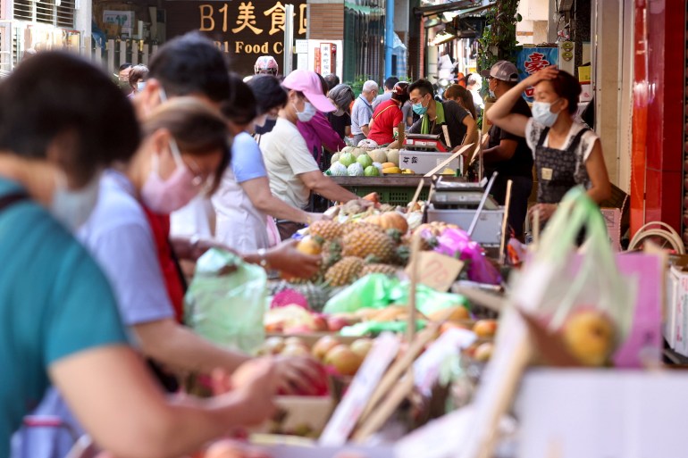 People wearing protective face masks shop at a market amid the coronavirus disease (COVID-19) pandemic, in Taipei, Taiwan, June 8, 2021 [Ann Wang/ Reuters]