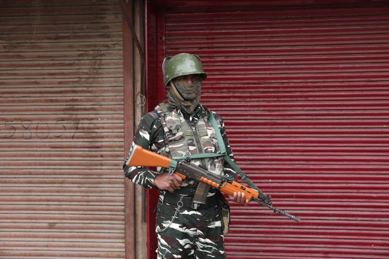 An Indian paramilitary soldier stands guard during lockdown in Srinagar, Indian-administered Kashmir [File: Farooq Khan/EPA]