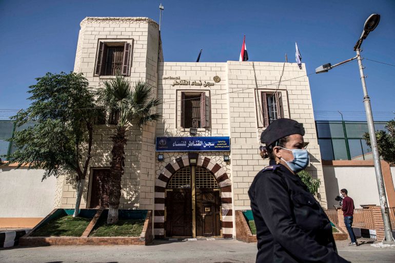 This picture taken during a government-guided tour on December 27, 2020 shows a policewoman standing outside the entrance to al-Qanatir women's prison