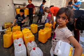 Palestinian children fill up gallons with water in Gaza City on May 20, 2021 [File: Mahmud Hams/AFP]