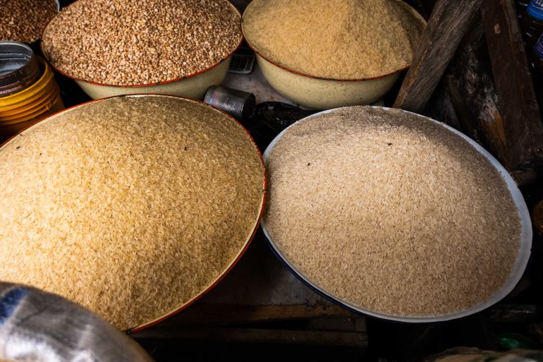 A general view of grains of Rice at Paul Chinedu's shop in a market at Illaje Bariga, Lagos, on June 29, 2021. - Since the start of the pandemic in 2019, food prices have risen by an average of more than 22%, according to official statistics, and feeding a family properly has become a daily challenge. (Photo by Benson Ibeabuchi / AFP)