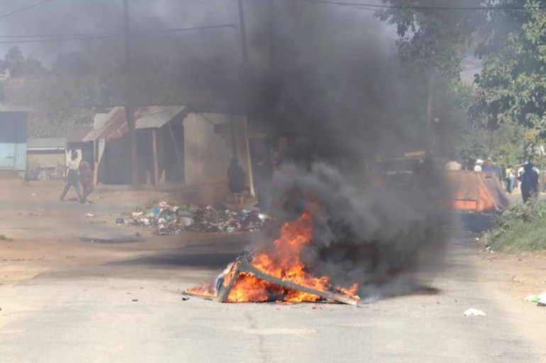 A barricade in the road that is on fire is seen in Mbabane, Eswatini, on June 29, 2021