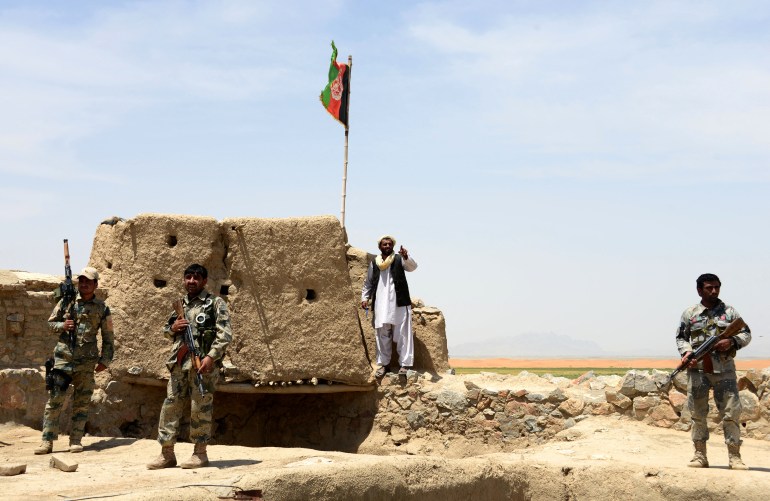 Afghan Border Police officers watch during the ongoing battle between Pakistan and Afghanistan Border Forces near the Durand line