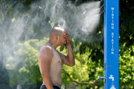 A man cools off at a misting station during the scorching weather of a heatwave in Vancouver, British Columbia, Canada