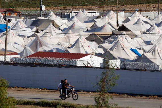 A man rides past Boynuyogun refugee camp in Hatay province on the Turkish-Syrian border