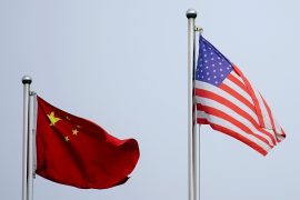 The flags of China and the United States flying next to each other.