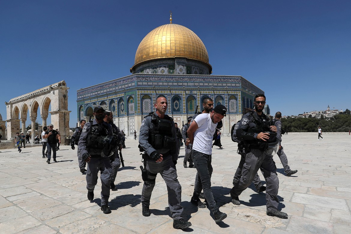 Israeli security force members detain a Palestinian at the compound that houses Al-Aqsa Mosque, known to Muslims as Noble Sanctuary and to Jews as Temple Mount, in Jerusalem's Old City. [Ammar Awad/Reuters]