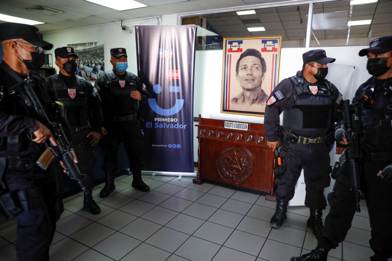 Anti-riot police stand inside the National Republican Alliance (ARENA) party headquarters during a raid executed by the National Civil Police and Attorney General's Office in capital, San Salvador, on Friday [Jose Cabezas/Reuters]