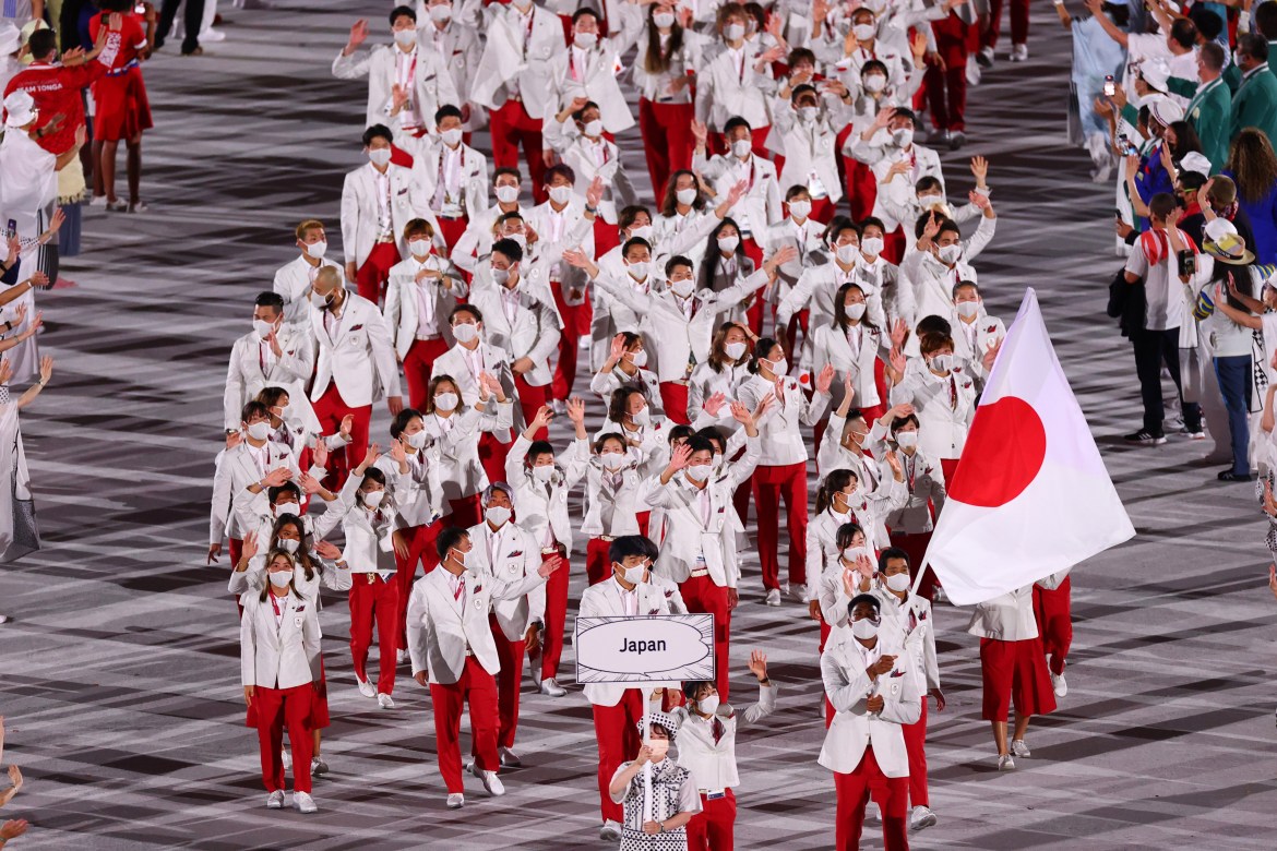 Japan was forced to hold the Games without fans. In this photo, flag bearers Yui Susaki and Rui Hachimura of Japan lead their contingent at the opening ceremony. [Mike Blake/Reuters]