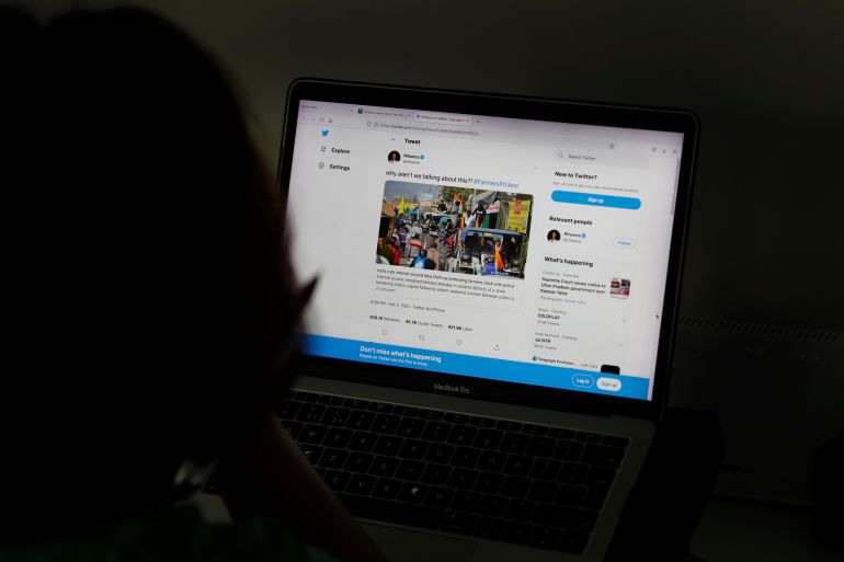 A woman looks at the Twitter page of pop star Rihanna in New Delhi, India