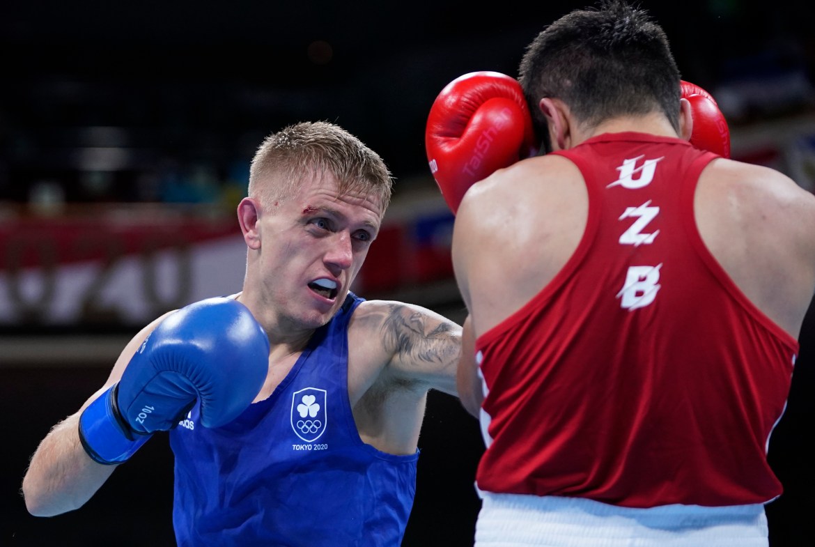 Ireland's Kurt Anthony Walker punches Uzbekistan's Mirazizbek Mirzakhalilov during the men's featherweight boxing match. [Frank Franklin II/AP Photo]