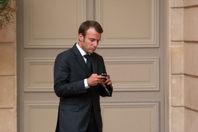French Economy Minister Emmanuel Macron uses his mobile phone as he arrives at a dinner attended by French President Francois Hollande and Saudi Arabia's Prince Salman Bin Abdulaziz Al Saud at the Elysee Palace in Paris, France, 01 September 2014.