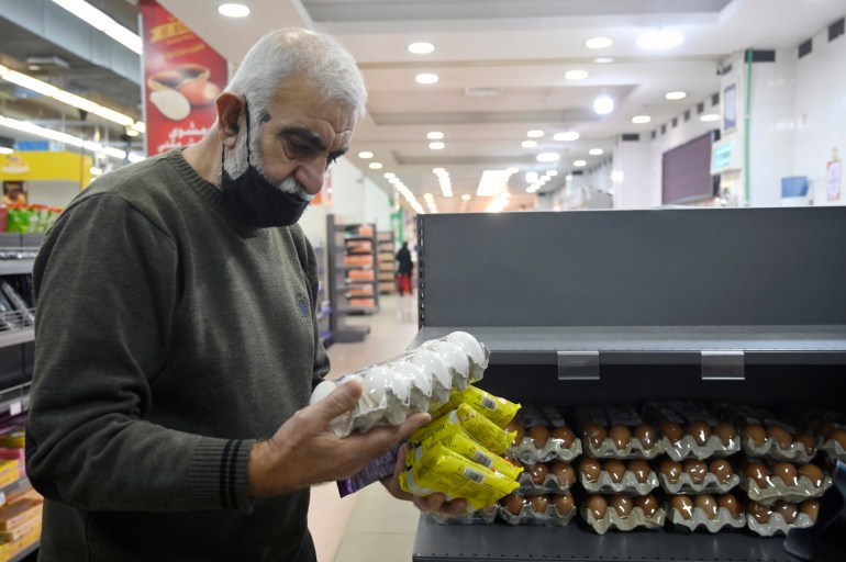 A customer looks at eggs price in a supermarket in Beirut, Lebanon, 24 March 2021.