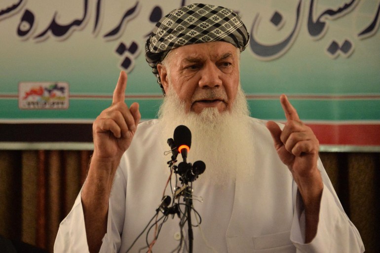 Afghan commander and former mujahideen leader Ismail Khan addresses a gathering at his house in Herat [AFP]