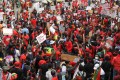 A crowd of protesters match on the streets of Accra