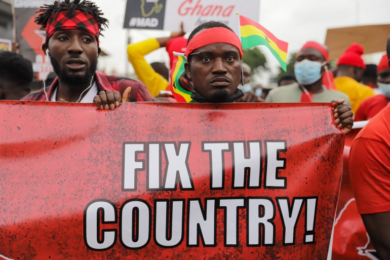 Protesters hold a banner during #fixthecountry protest in Accra, Ghana, on August 4, 2021