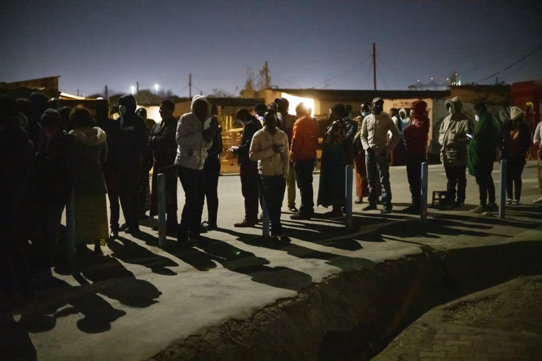Voters waiting for a polling station to open in Lusaka [Maroc Longari/AFP]