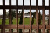 The main house of the Whitney Plantation is seen through the bars of a steel cage used as a jail in Wallace, Louisiana, US, January 13, 2015 [File: Edmund Fountain/Reuters]
