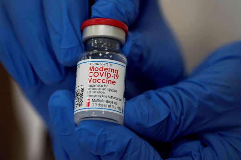 An employee shows the Moderna COVID-19 vaccine at Northwell Health's Long Island Jewish Valley Stream hospital in New York, U.S.