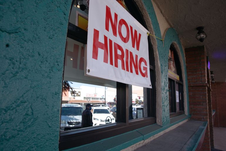 A "Now Hiring" sign outside a restaurant in Huntington Park, California, US
