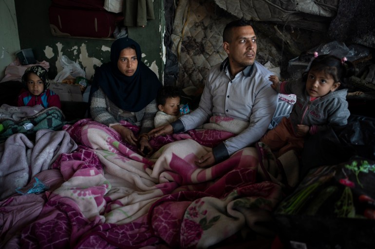 A family from Afghanistan gathers at an abandoned building in Edirne, near the Turkish-Greek border