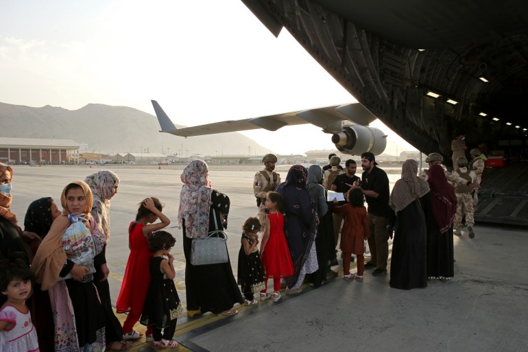 Afghans evacuated aboard a Qatari transport plane